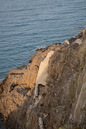 Broken path beside a rocky shore