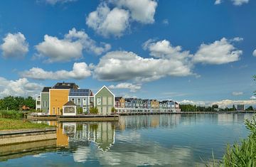 Coloured houses at Rietplas, blue sky with clouds by Ad Jekel