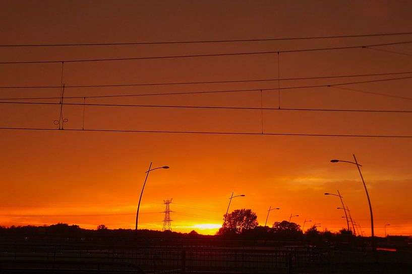 Sunset over the road and railway line by Vincent van der Tuin