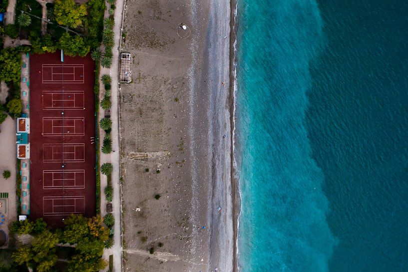 Stadium by the sea. green park on the seafront with turquoise water and the beach. top down view by Michael Semenov