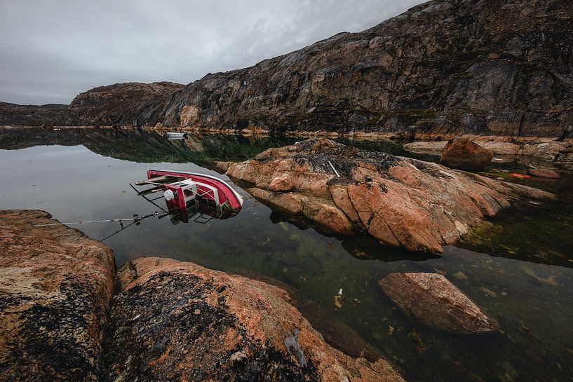 Sunken boat in a bay in Greenland by Martijn Smeets