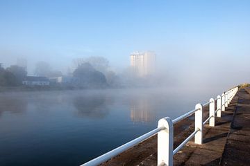 Water sports course with emerging fog banks over the water by Marcel Derweduwen