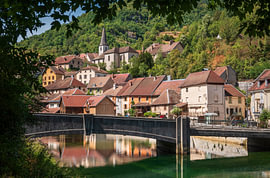 Village of Lods framed by trees in Doubs department - France by Laurent Renault