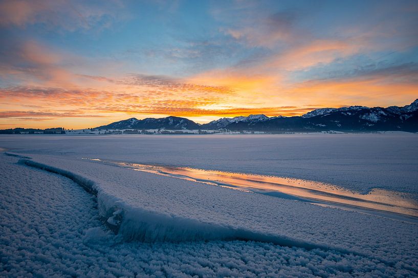 Sunrise over frozen lake Forggensee by Leo Schindzielorz
