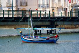 Boat floats lonely on the water by Tom Vogels