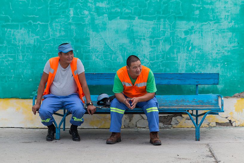 Station workers in Mongolia rest on a bench by Andre Brasse Photography