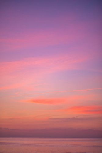 Pink orange sunset sky over the sea