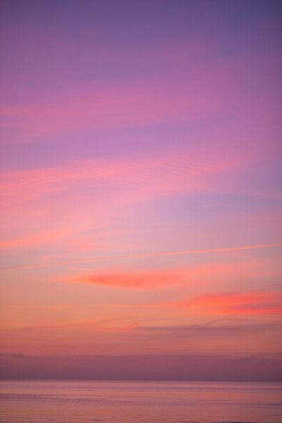 Pink orange sunset sky over the sea by Charlotte Van Der Gaag