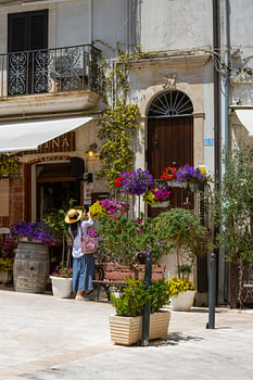 A Sunny Italian Street Filled with Beautiful Flowers