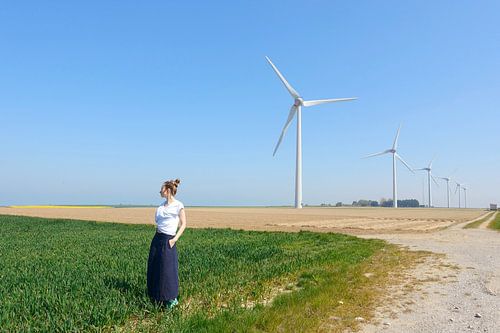 Windmills in the field and a woman