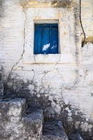 Blue window in facade with stone steps