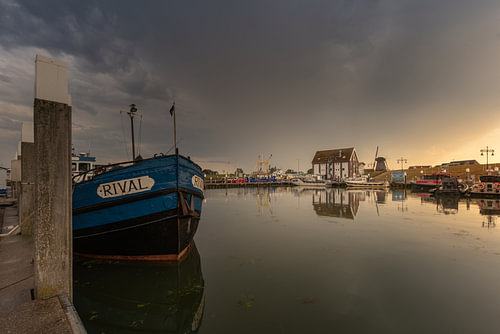 Oudeschild harbour at sunset with stormy skies