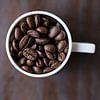 Koffiebonen in koffiekopje 11452159 van BeeldigBeeld Food & Lifestyle