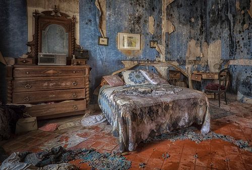Bett im verfallenen blauen Raum
