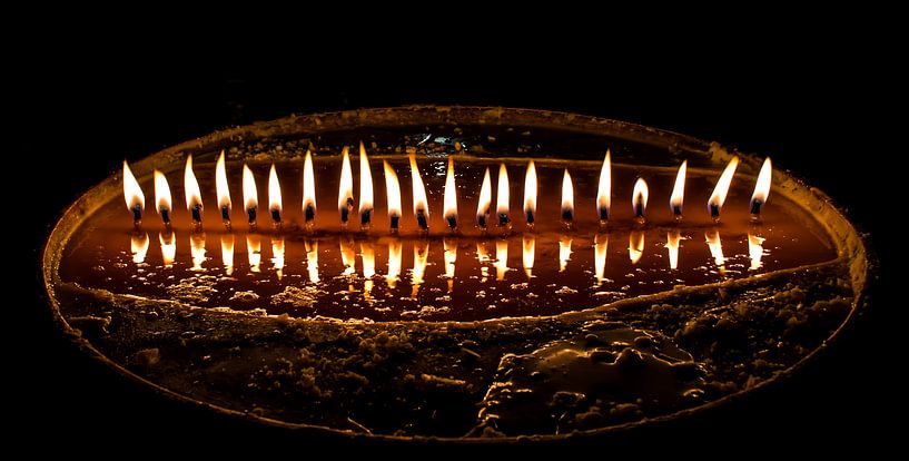 Brennen Butter Kerzen in einem dunklen Tempel in Tibet von Rietje Bulthuis