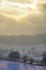 Sunbeams over winter landscape by The Book of Wandering