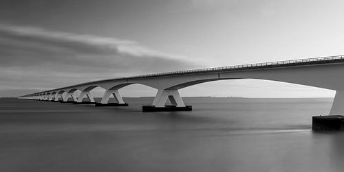 Sea bridge long shutter speed in black and white by Marjolein van Middelkoop