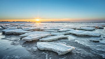 Ice floes on the Wadden Sea during sunset