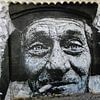 Muurschildering van een rokende man in Lagos- Portugal van Ineke de Rijk