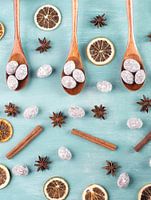 Spiced almonds with anise stars and cinnamon on blue background