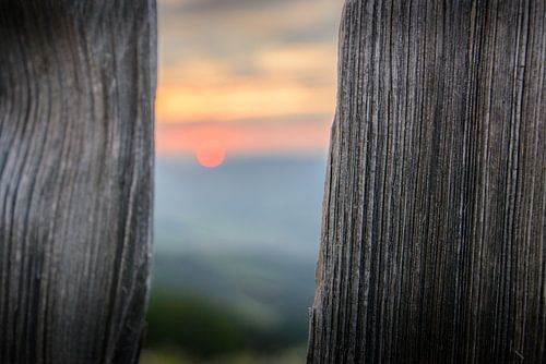 Sunset behind a fence