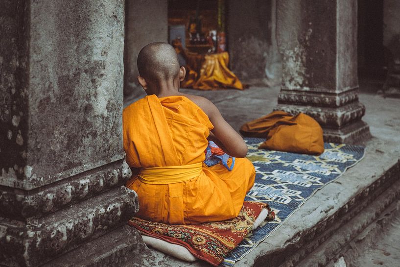 Buddhist child in Angkor Wat, Cambodia by Karlijne Geudens