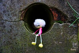 Fubby doll sitting in a wall. A cute little girl.