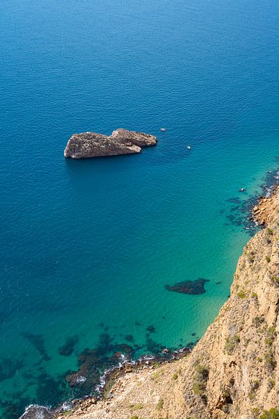 Island in clear, turquoise blue sea water by Adriana Mueller