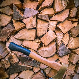 Wood pile with axe by Ferry D