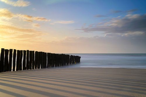 Posts by the sea at sunset