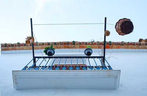 Modern photo of a balcony with flowerpots seen from below.