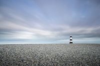Lonely lighthouse between gravel and water