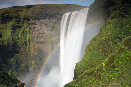 Skogafoss waterfall with rainbow in Iceland