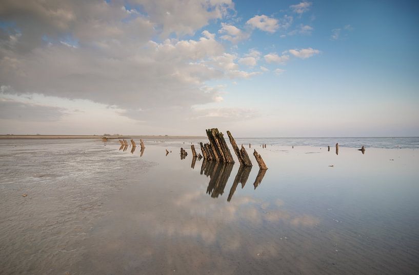 Beautiful reflection of wooden poles in the sea by Patrick Verhoef
