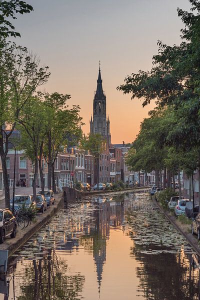 Delft - big church sunset. orange blue sky. canal by Erik van 't Hof