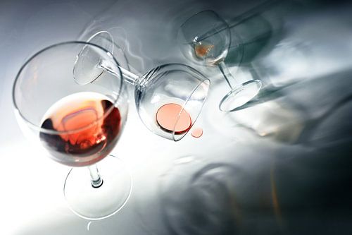 Glasses with red wine, standing, falling and rolling in unusual perspectives, abstract concept of a 