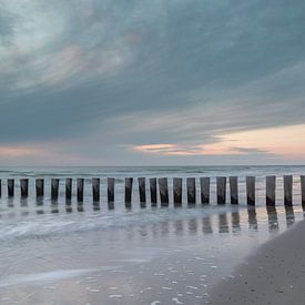 Wooden breakwaters on the tranquil coast of Ameland at dusk by Heidi Bol
