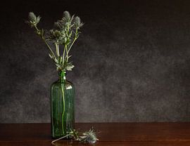 A bunch of thistles in a green bottle by Irene Ruysch fotografie