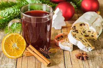 Mulled wine and christmas stollen with decorations on wooden table by Alex Winter