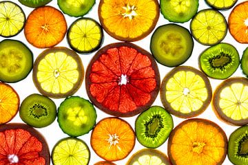 Collage of slices of fruit and vegetables with a white background. by Carola Schellekens