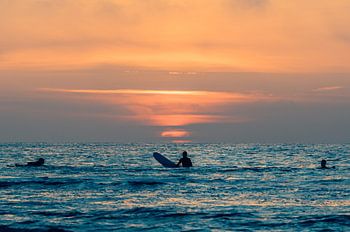 Surfers bewonderen de zonsondergang bij Terschelling