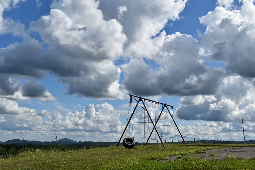 A swing in the schoolyard in summer by Claude Laprise