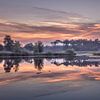 Sunrise with reflection in fen in the Netherlands by Michel Seelen
