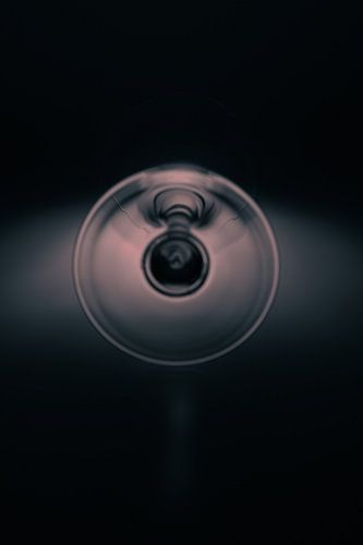 Wine glass on soft blue and orange coloured background