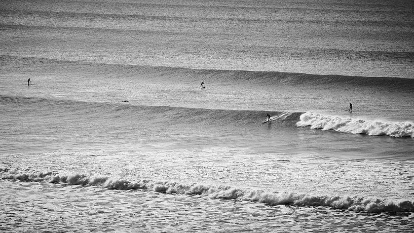 Lijnenspel van de golven met surfers in zwart wit van Marloes van Pareren