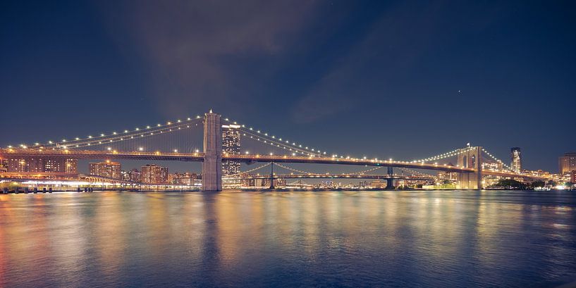 Brooklyn Bridge over East River in New York City at night by Robert Ruidl