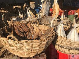 Dried fish in baskets by stephanie van gent