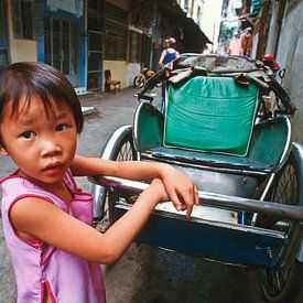 Little girl at a parked cyclo in Ho Chi Minh City by Silva Wischeropp