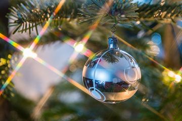 Stervormige lichtjes en zilverkleurige kerstbal van Wim Stolwerk