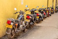 Row of scooters in a small street in Colombo, Sri Lanka